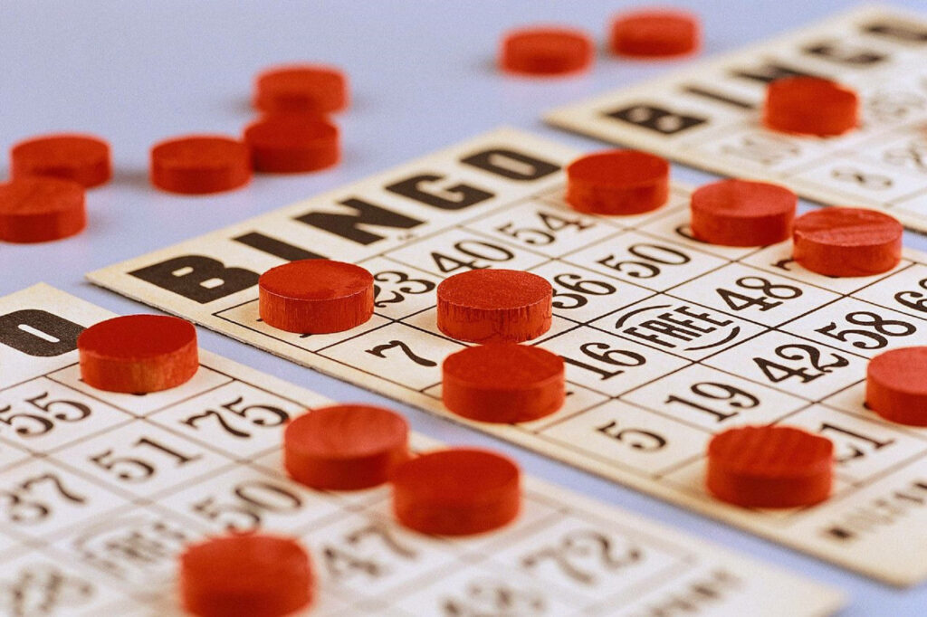 Classic bingo cards with vibrant red markers on a colorful wallpaper background showcasing game excitement