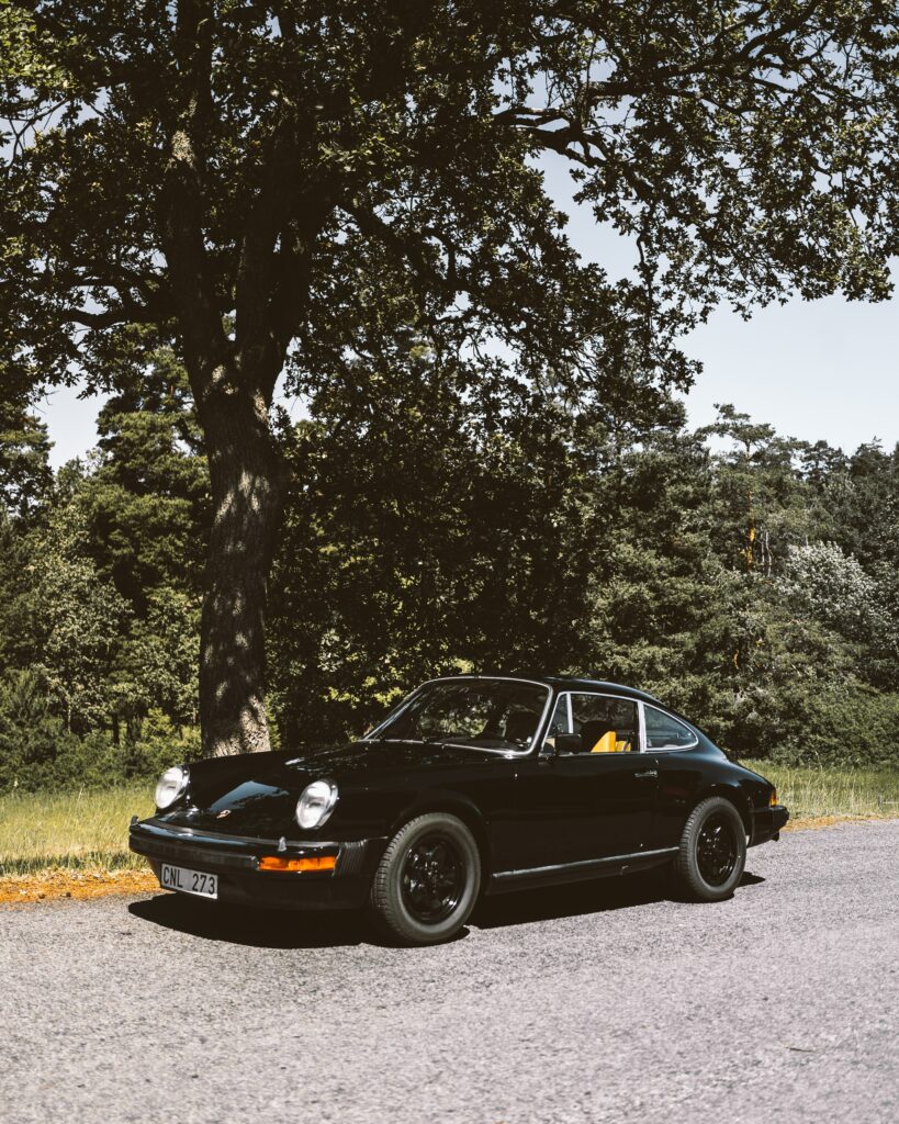 Classic Black Car Wallpaper: Vintage Vehicle by Rural Road