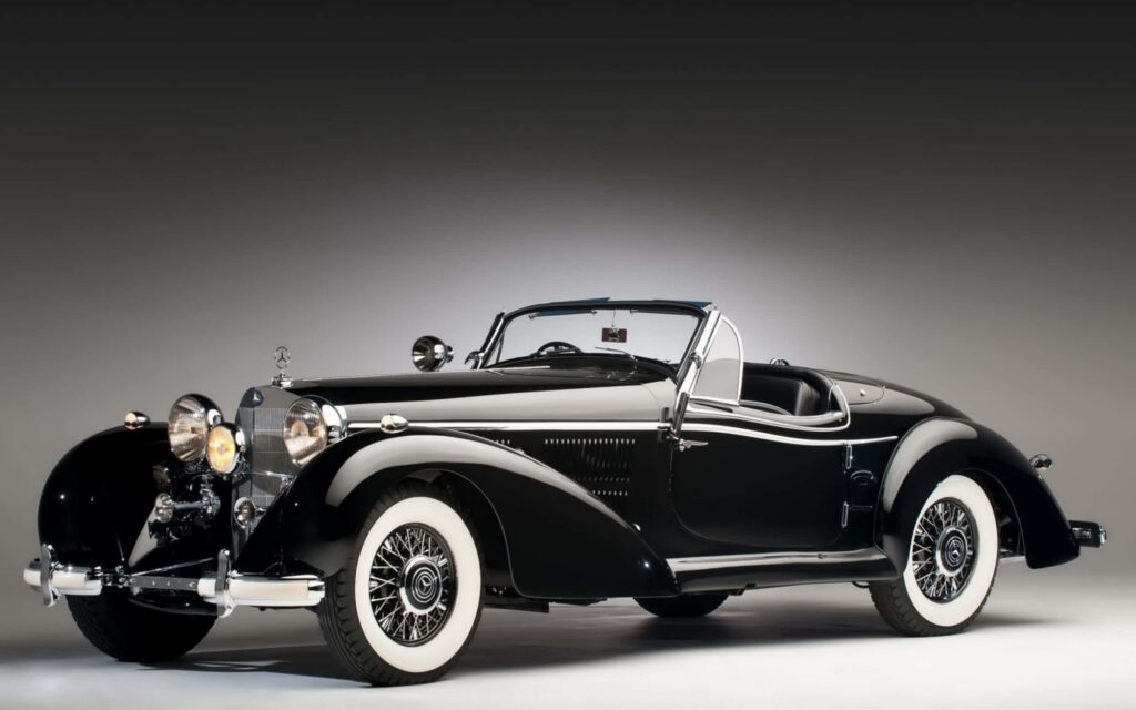 Classic black convertible car with sleek design and glossy finish ready for adventure wallpaper