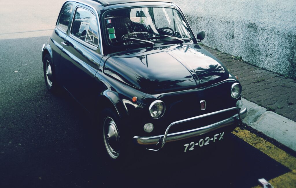 Vintage Black Fiat Car Wallpaper – Retro Charm in Urban Setting