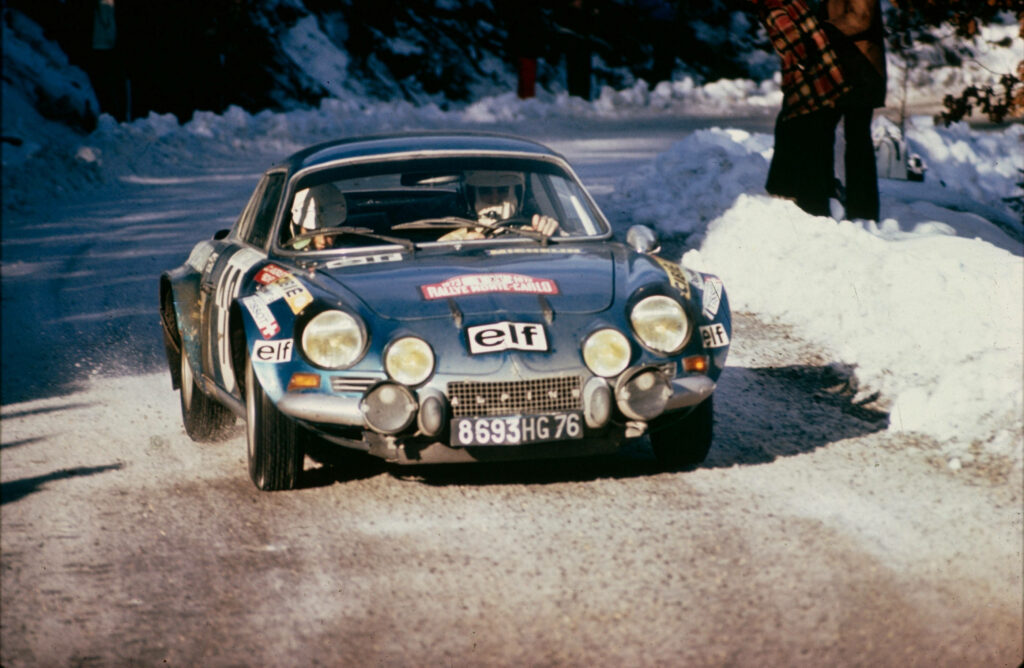 Classic blue Alpine Renault A110 racing fast on snowy mountain rally showcasing vintage design Wallpaper