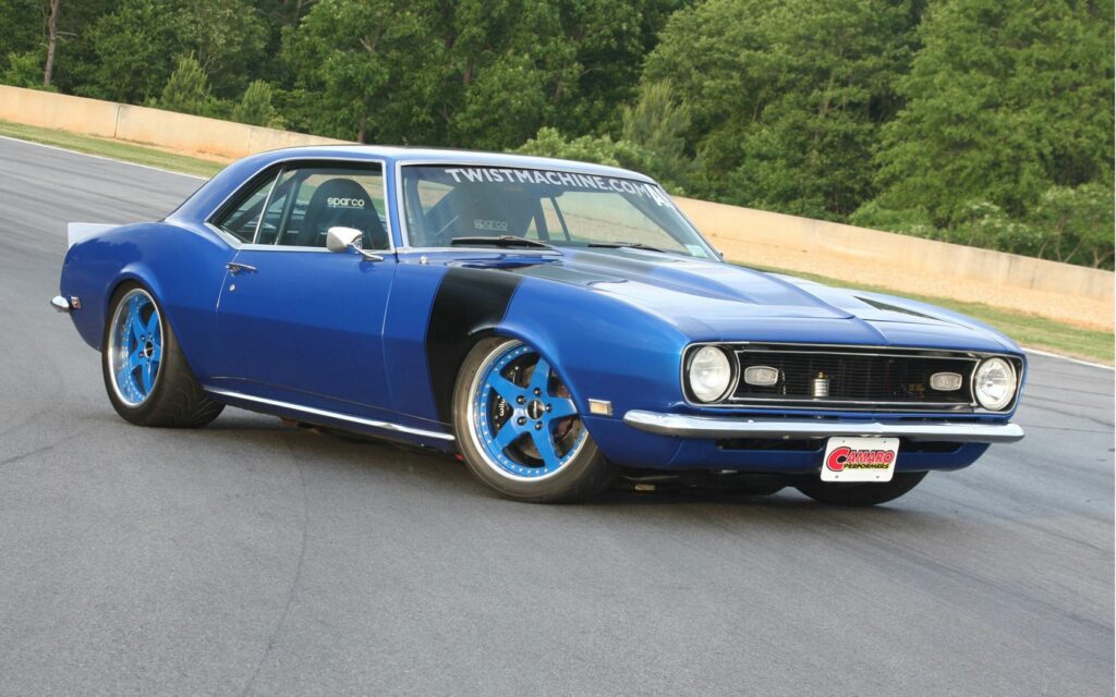 Classic Blue Chevrolet Camaro Wallpaper on Scenic Road Background