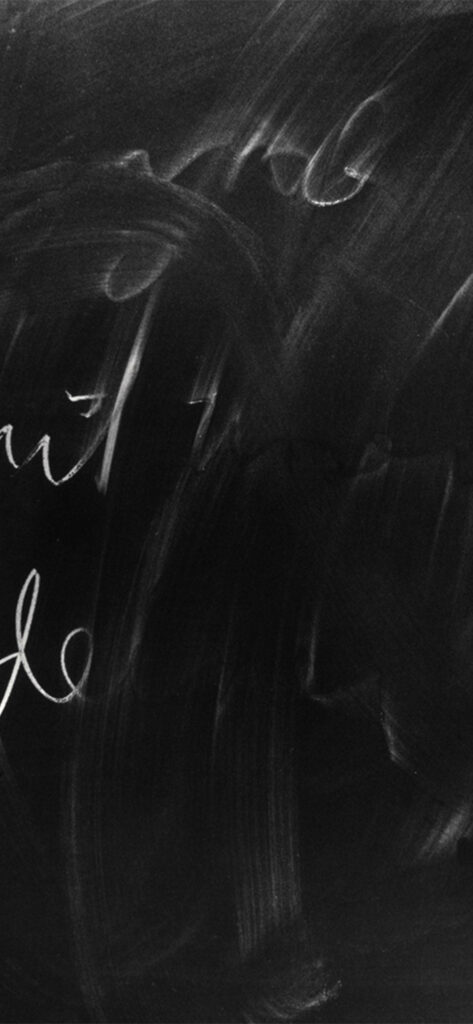 Classic chalkboard wallpaper with smudges and faint chalk marks for educational themes