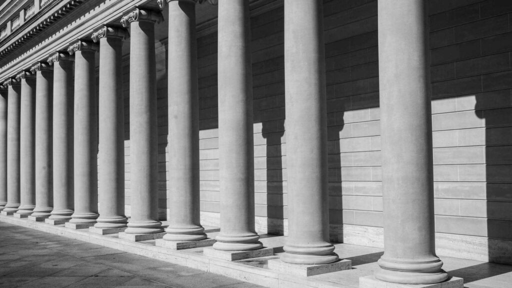 Timeless Black and White Wallpaper of Classic Columns and Shadows