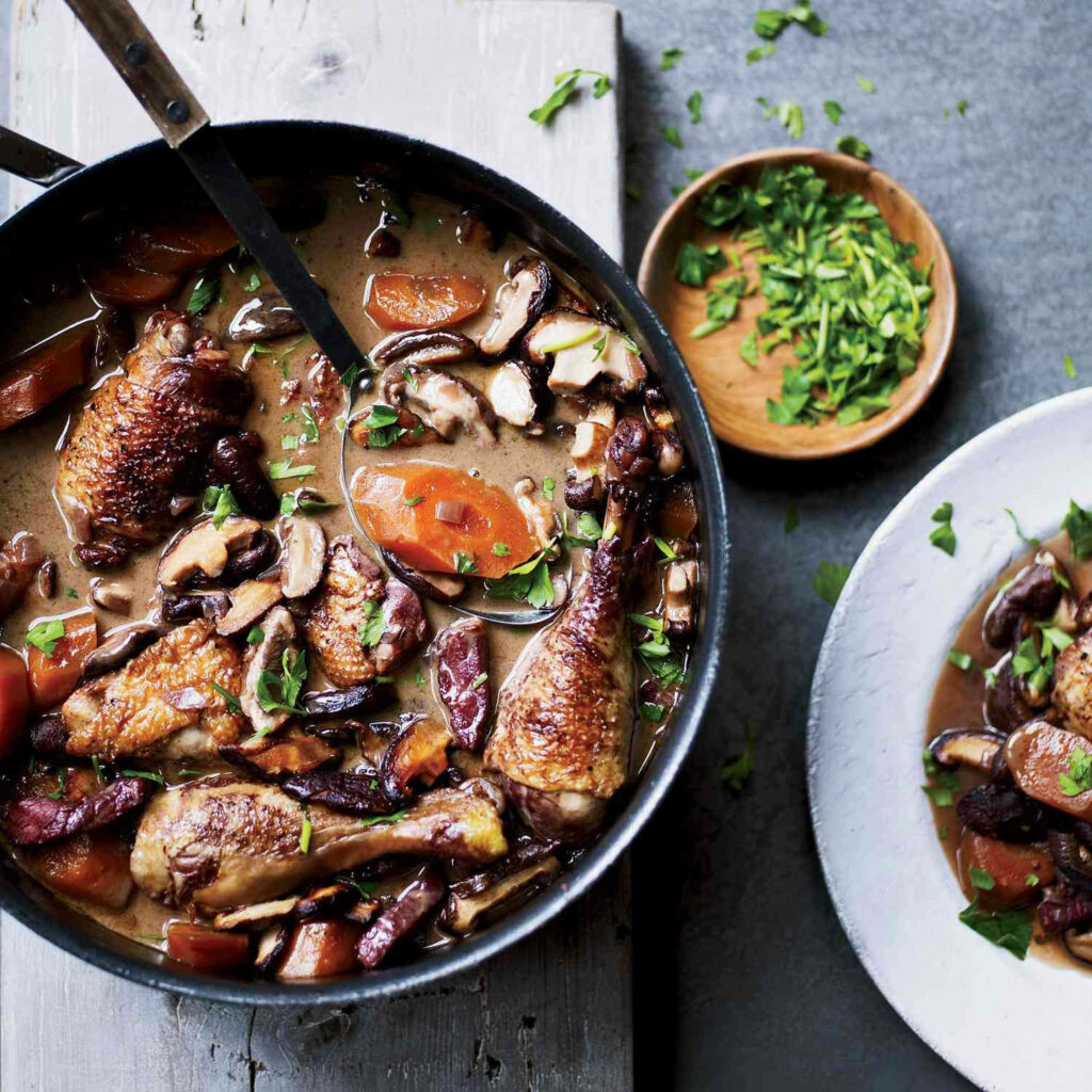 Coq Au Vin Wallpaper: Classic French Dish in Rustic Skillet