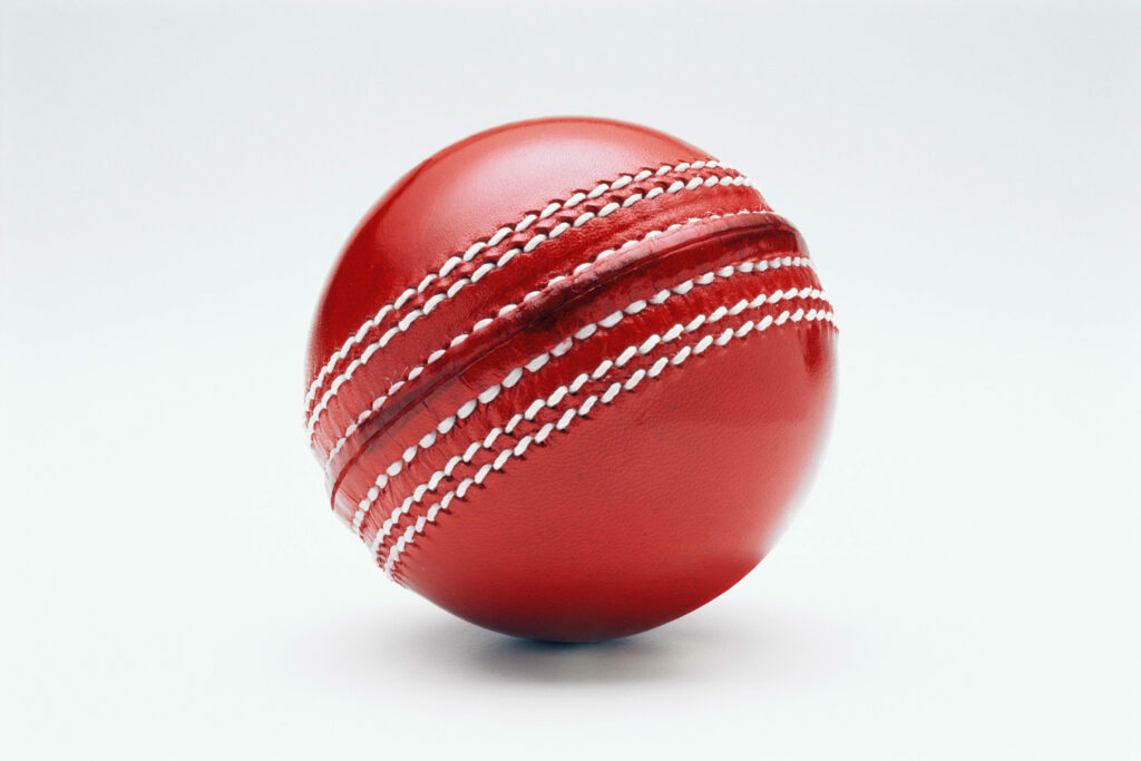 Vivid Red Sphere: Minimalistic Cricket Ball Wallpaper