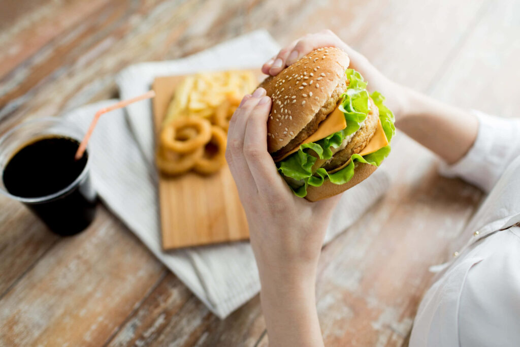 Classic Fast Food Meal: Cheeseburger, Fries, Onion Rings & Soda Wallpaper