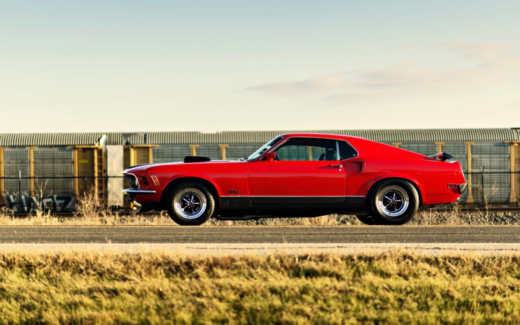 Iconic Ford Mustang Mach 1 Wallpaper - Vibrant Red Muscle Car