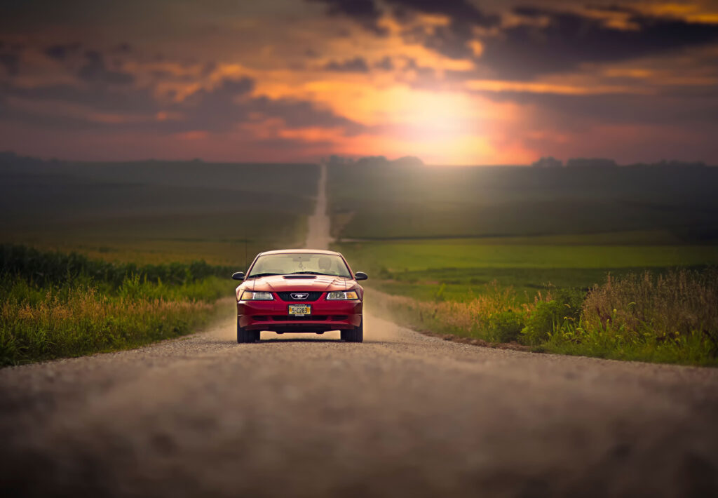 Classic Ford Mustang at Sunset: Serene Rural Road Wallpaper