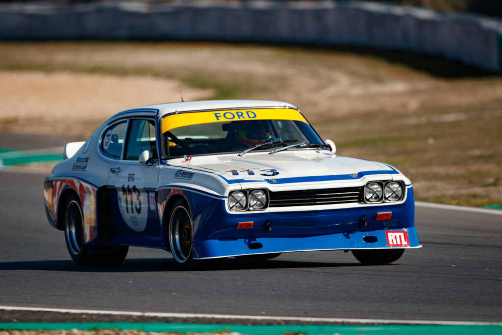 Classic Ford Race Car in Action: High-Performance Racing Wallpaper