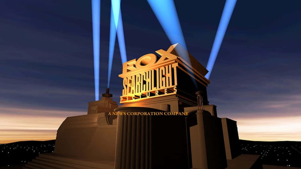 Fox Searchlight Pictures logo with golden letters and blue spotlights in twilight sky background Wallpaper