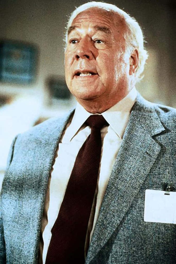 George Kennedy classic portrait in grey herringbone blazer vintage cinematic wallpaper background