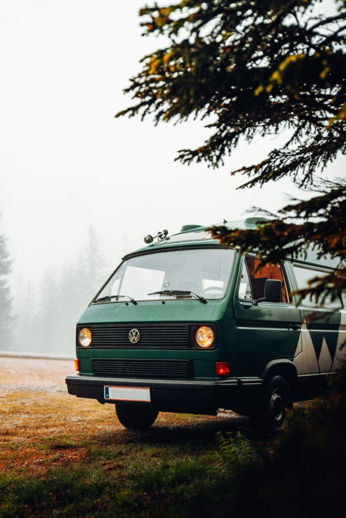 Serene Green VW Van in Misty Nature - Perfect Camping Background Wallpaper
