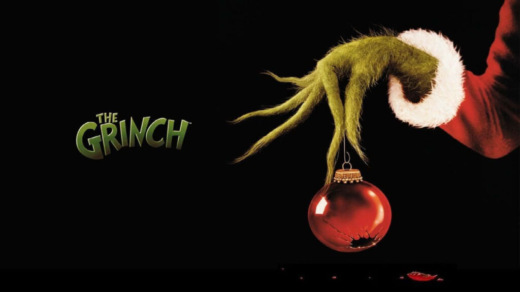 Grinch's Green Hand Holding Cracked Ornament - Festive Wallpaper