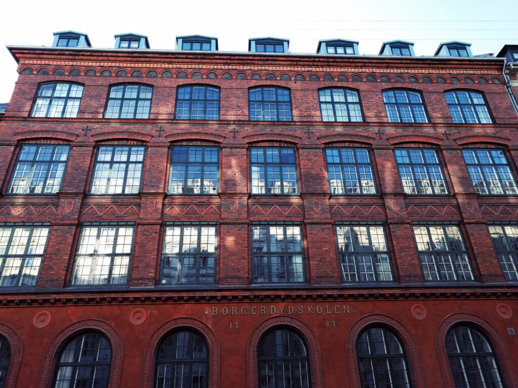 Historic Brick Building Facade Wallpaper with Arched Windows