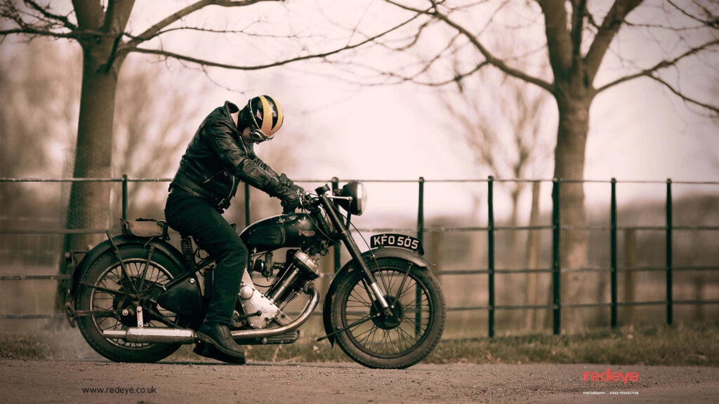 Classic Motorcycle Adventure: Biker in Serene Countryside Wallpaper