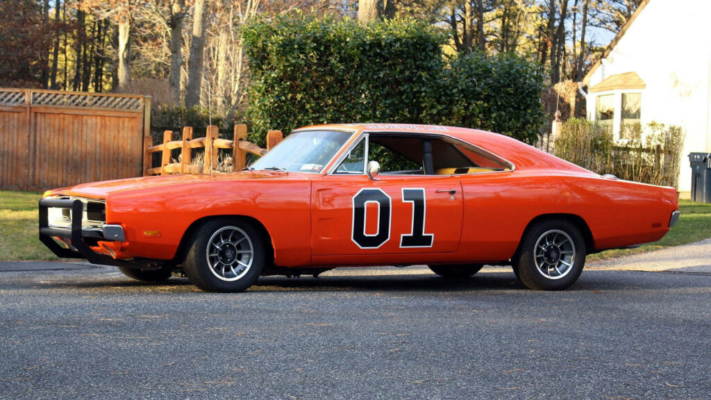 Classic orange Dodge Charger General Lee side view with number 01 against suburban wallpaper background