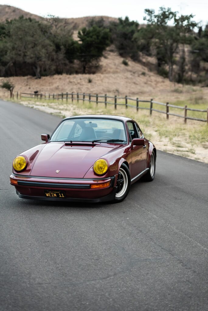 Classic Porsche 911 SC in Striking Red - Scenic Outdoor Wallpaper