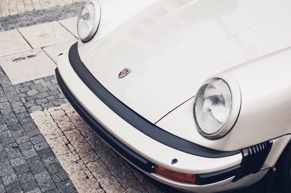 Elegant Classic Porsche Wallpaper: Iconic Bumper & Logo Close-Up