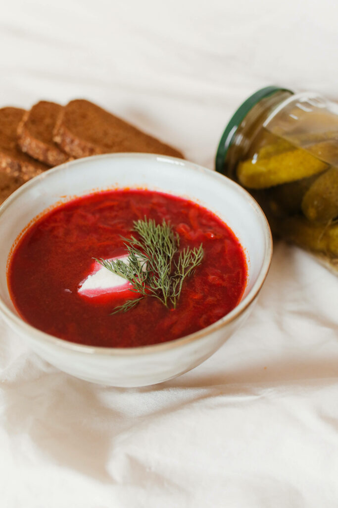 Classic Red Borscht Soup Wallpaper with Rye Bread & Pickles