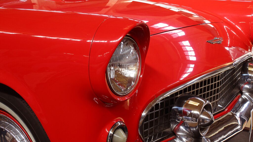 Elegant Retro Red Car Wallpaper: Close-Up of Chrome & Vintage Design