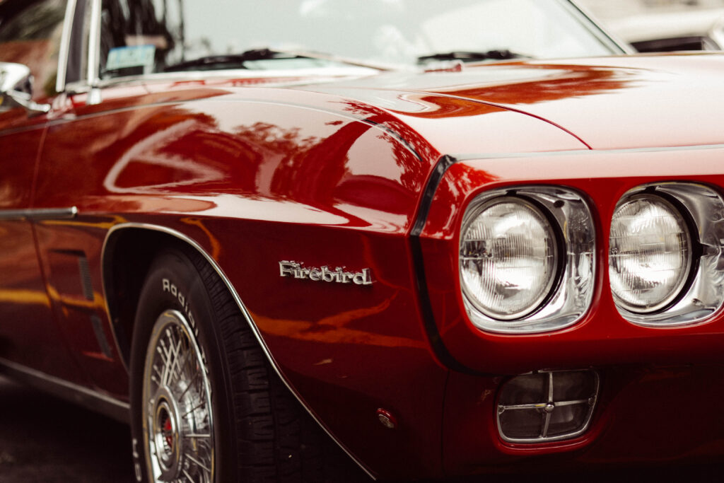 Classic Red Firebird Close-Up: Sleek Design & Vintage Chrome Accents Wallpaper