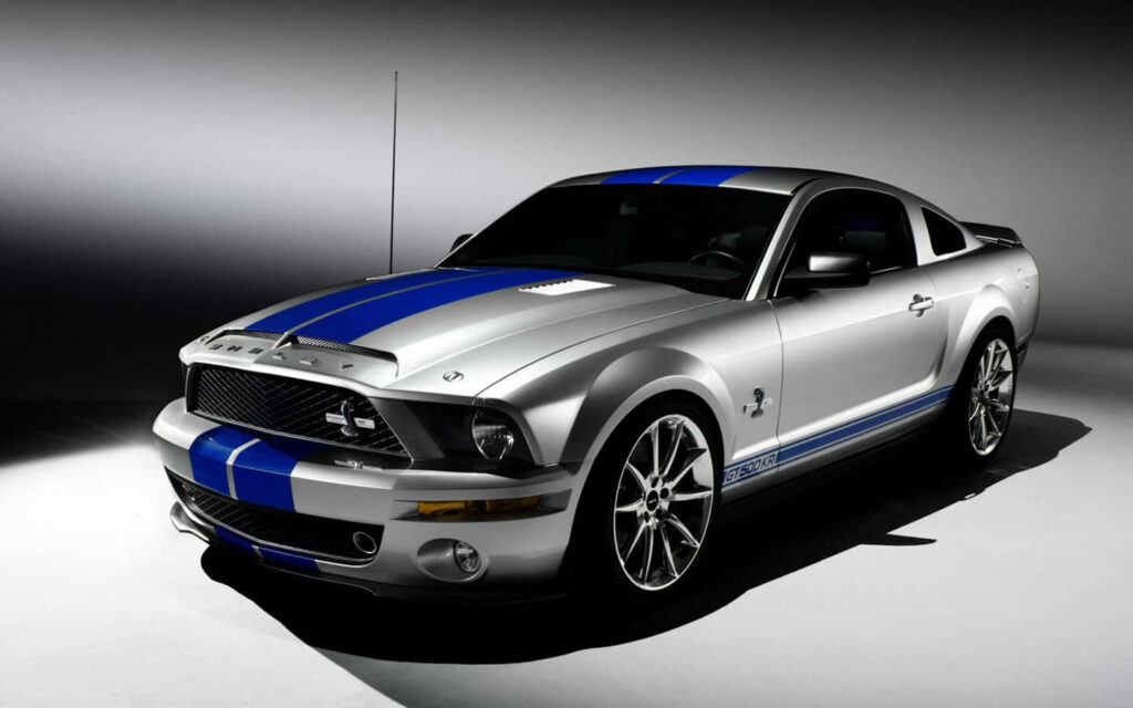 Silver Shelby GT500KR muscle car with blue stripes studio lighting minimalist background wallpaper