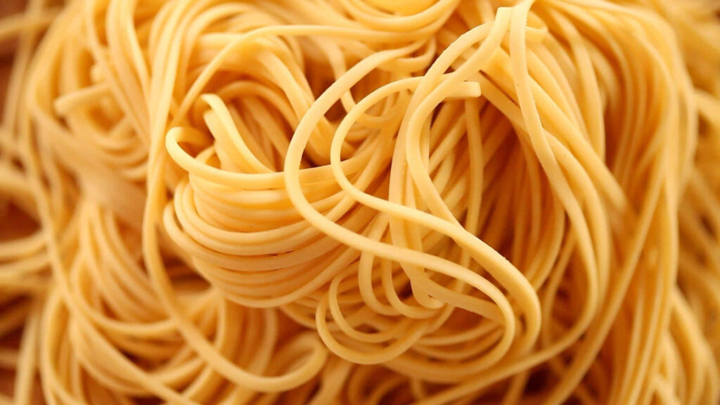 Classic Spaghetti Noodles: Smooth Texture & Golden Hue Wallpaper
