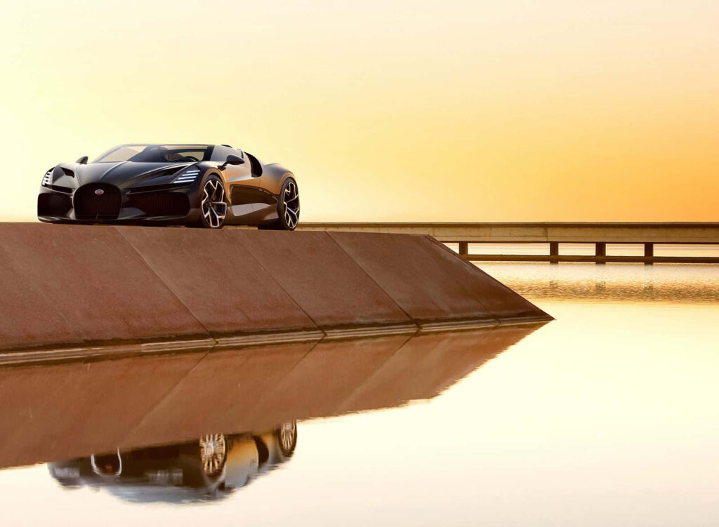 High speed classic sports car parked on concrete ramp reflecting in water at golden sunset Wallpaper