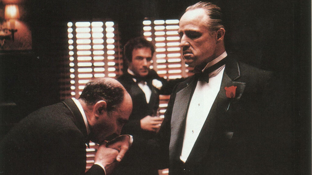 Classic Godfather Scene: Loyalty Kiss with Don Vito Corleone Wallpaper