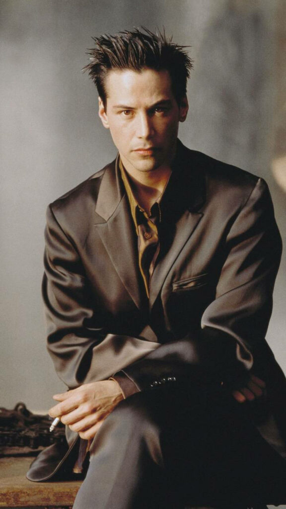 Elegant Wallpaper: Young Keanu Reeves in Formal Suit - Vintage Charm