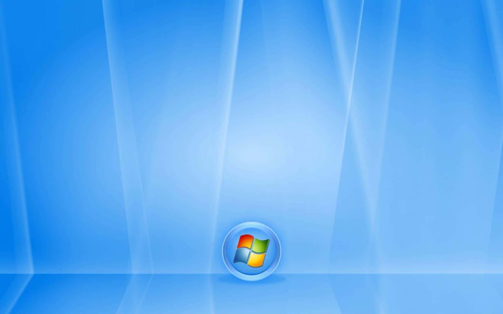 Classic Windows Vista wallpaper with blue waves and centered circular Windows logo background