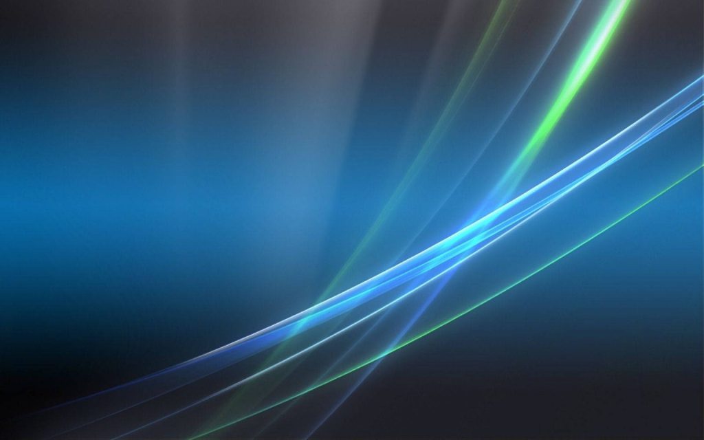 Windows Vista wallpaper with flowing blue and green ribbons on dark gradient background