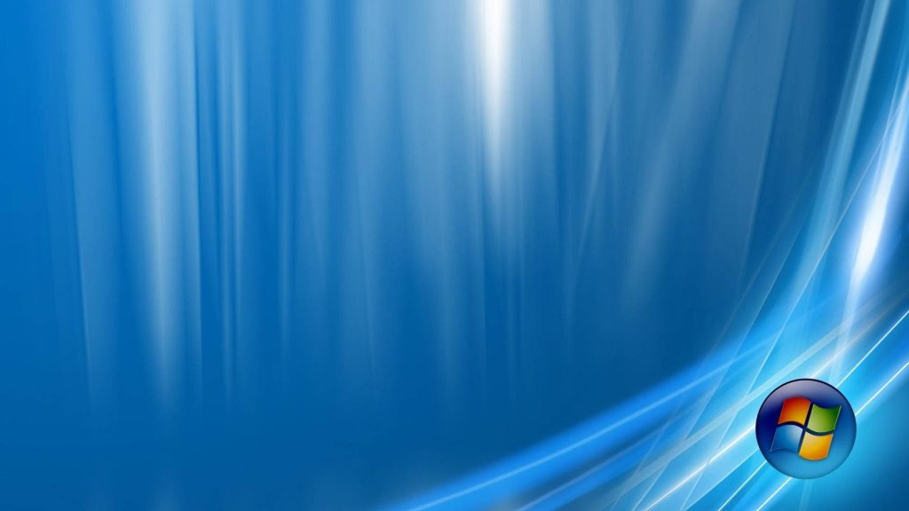 Windows Vista wallpaper with deep cerulean waves and glowing light rays featuring orb logo