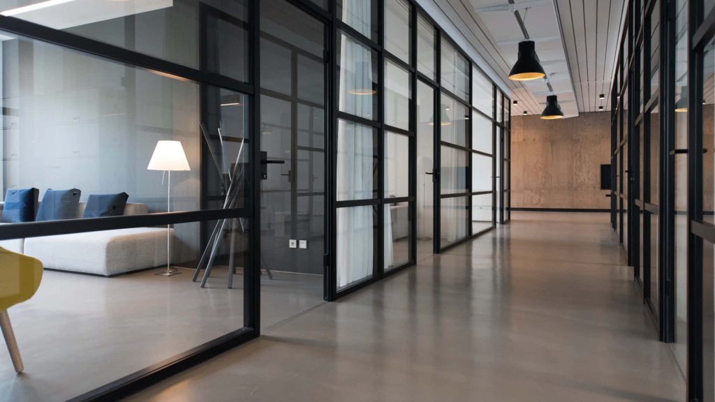 Modern virtual conference room background with sleek glass partitions and polished concrete floors Wallpaper