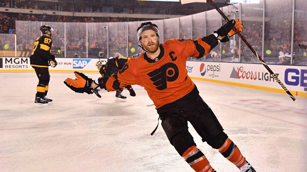 Claude Giroux celebrates on ice wearing vibrant orange Philadelphia Flyers jersey in NHL stadium Wallpaper