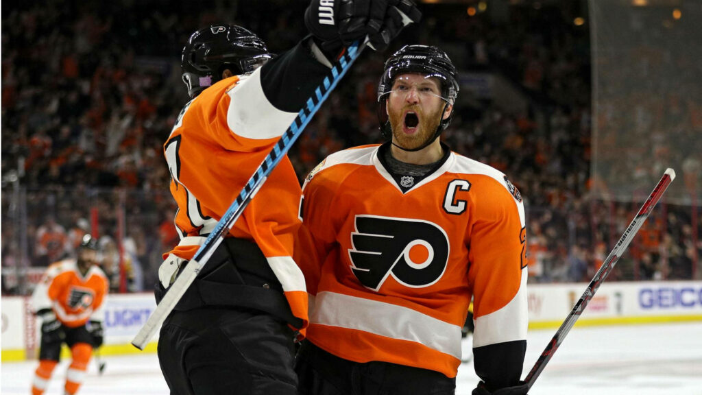 Claude Giroux celebrates passionately on ice wearing Philadelphia Flyers orange and black uniform wallpaper