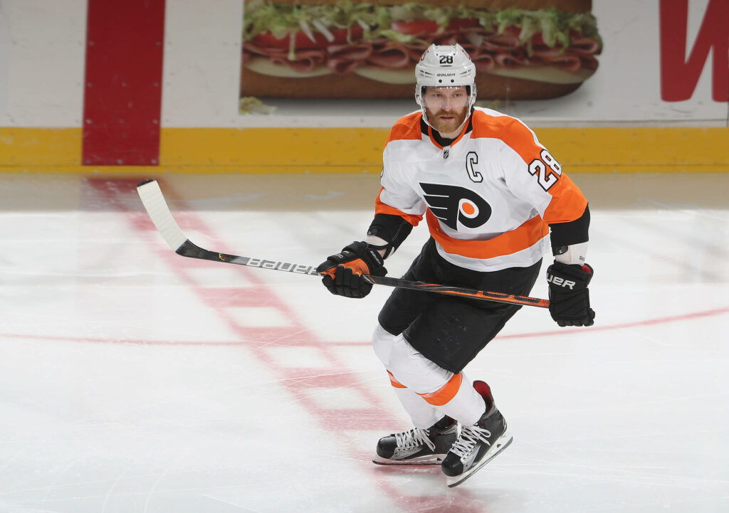 Claude Giroux Philly Flyers captain skating fast on ice during intense NHL hockey game action Wallpaper