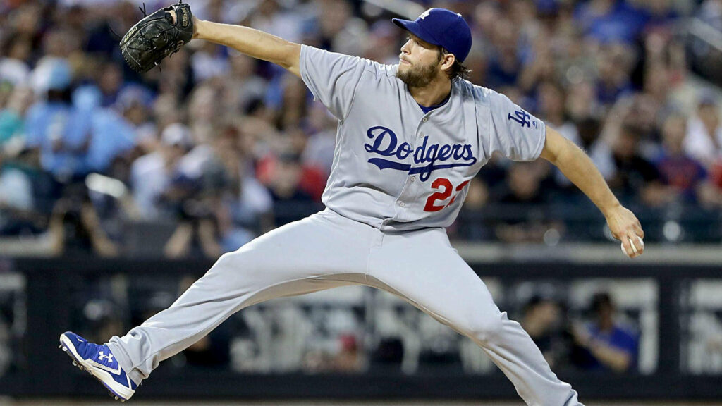 Clayton Kershaw pitching in Dodgers gray uniform showing intense focus and athletic power Wallpaper
