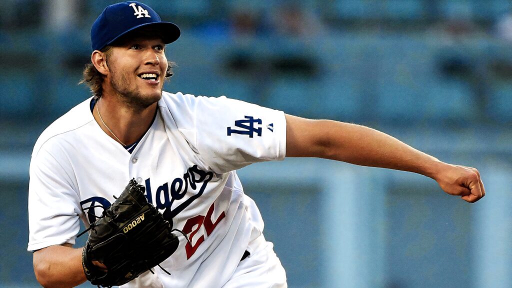 Clayton Kershaw pitching in Los Angeles Dodgers uniform showing focus and passion on field Wallpaper