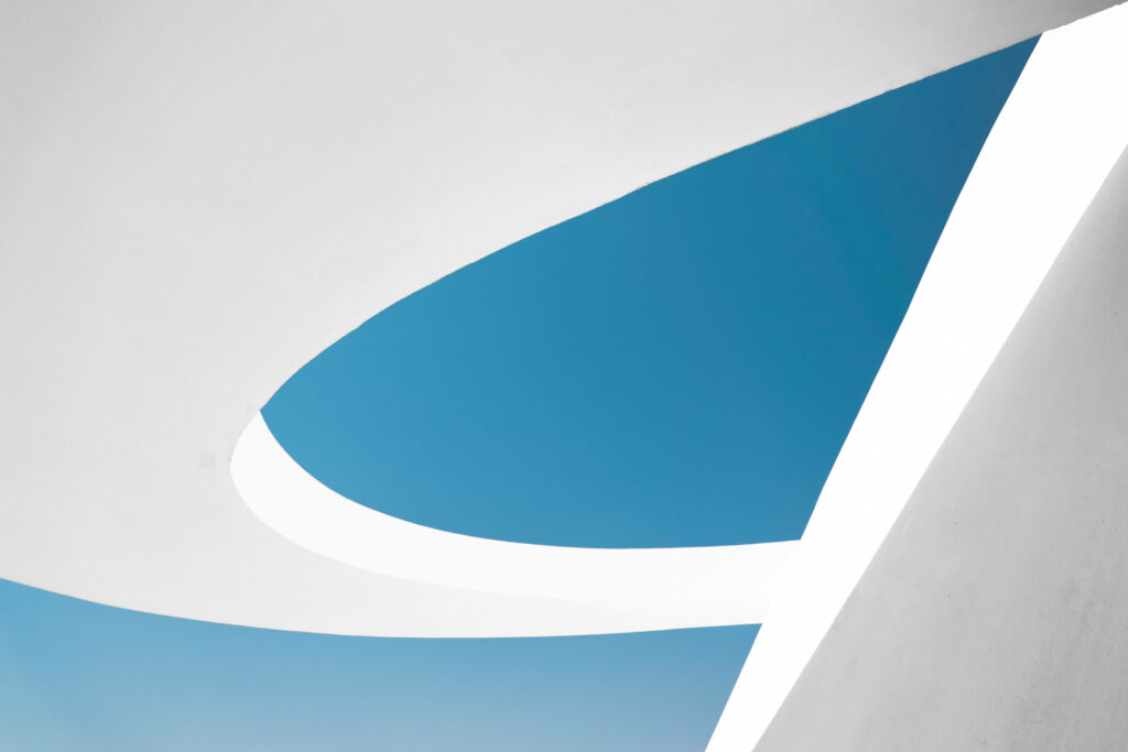 Modern White Geometric Architecture Contrast with Blue Sky Background Wallpaper