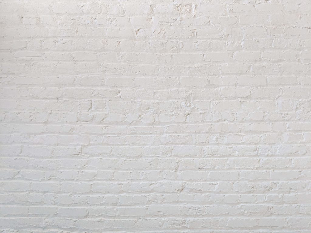 Clean white painted brick wall with soft lighting minimalist matte simple Zoom background wallpaper