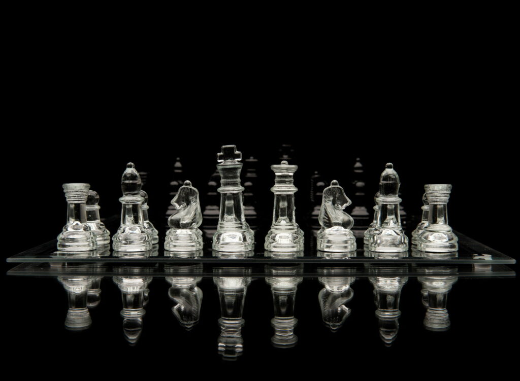 The Transparent Battle: A Clear Reflection of the Chess Game on Glass Wallpaper