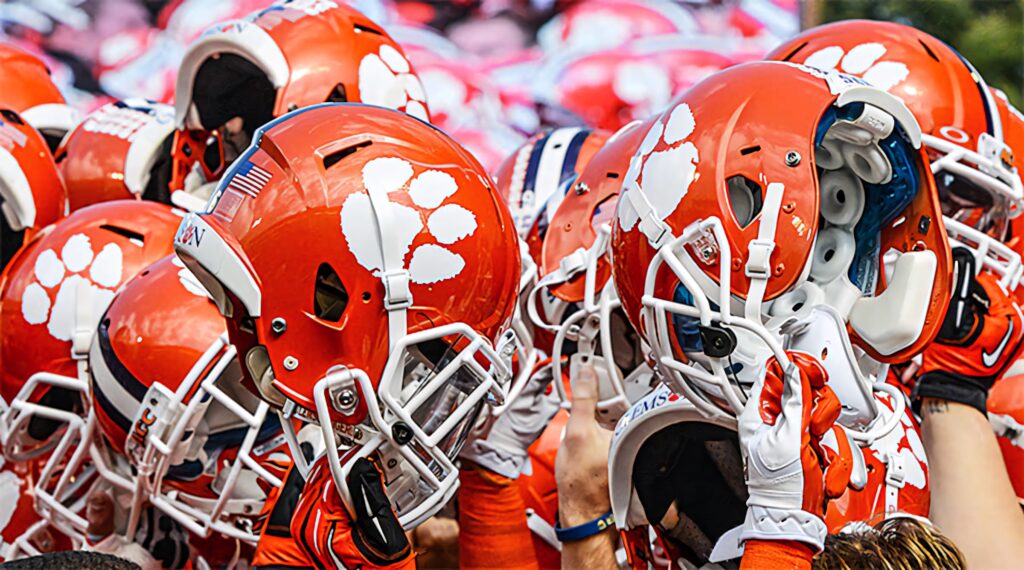 Clemson Tigers football helmets with white tiger paw logo vibrant orange team unity wallpaper background