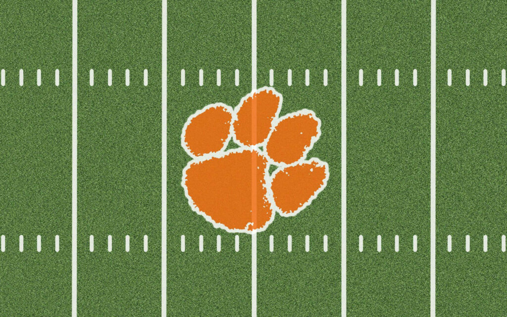 Clemson Tigers orange football paw logo centered on green field with white yard lines wallpaper