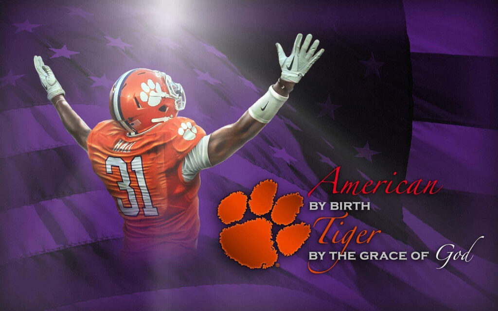 Clemson Tigers football player with raised arms against purple American flag showing heritage faith Wallpaper