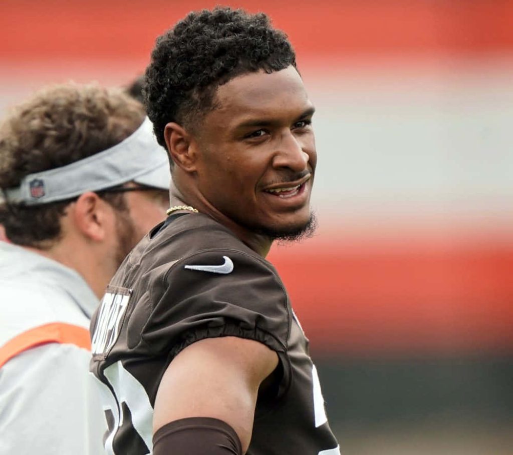 Cleveland Browns safety Grant Delpit in brown jersey during intense NFL training session wallpaper