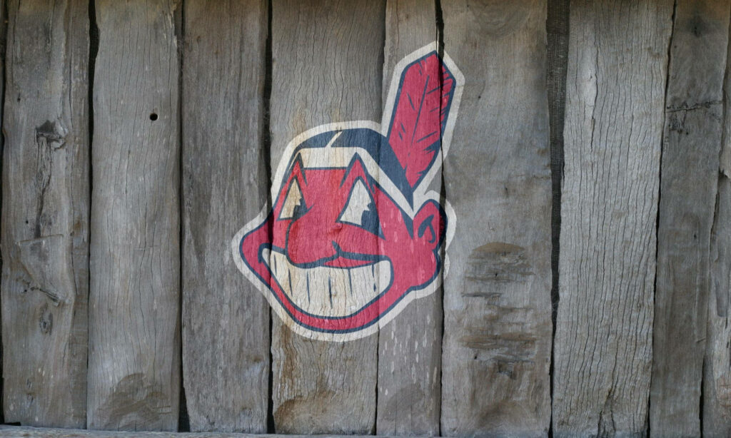 Cleveland Indians vintage logo on rustic wooden planks with red white and black colors wallpaper