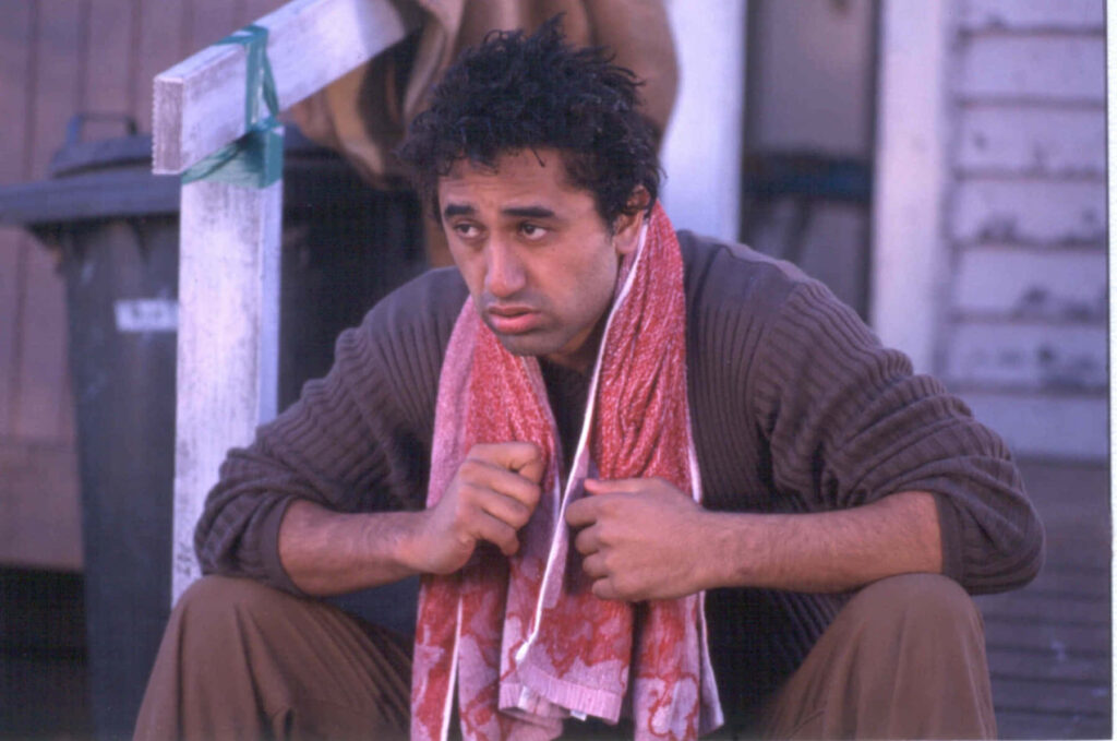 Cliff Curtis candid contemplative portrait outdoors with patterned towel rustic wooden background Wallpaper