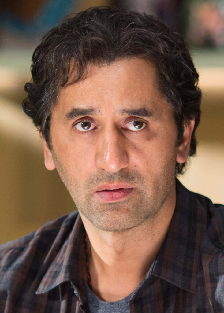 Close-up portrait of Cliff Curtis with expressive eyes and wavy hair on warm neutral background Wallpaper